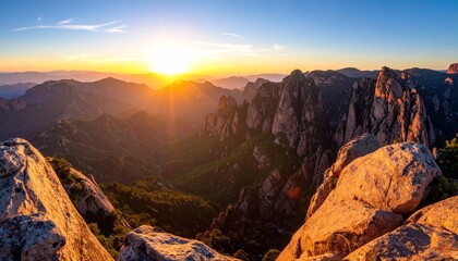 Fototapeta premium Golden Sunrise Over Majestic Mountain Peaks and Rocky Outcrops