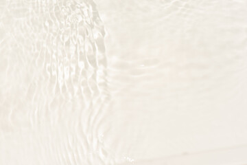 White water with ripples on the surface. Defocus blurred transparent white colored clear calm water surface texture with splashes and bubbles. Water waves with shining pattern texture background.