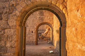 ancient arch with modern metal support from collapse in caesarea israel. in the evening in the light of the setting sun