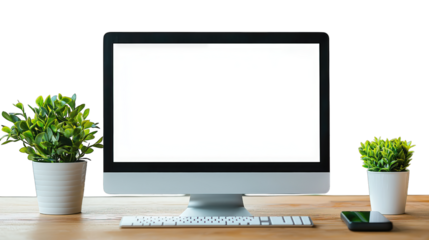 Computer with blank white screen on desk with small potted plants