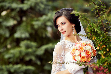 A woman wearing a white dress and holding a bouquet of flowers