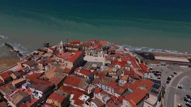Termoli fortified old town aerial. Puglia, Italy aerial. Colorful rooftops, deep blue sea and beaches