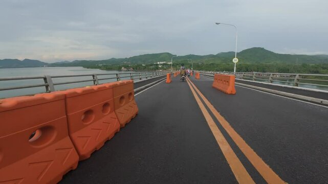 tourist driving over the San Juanico Bridge that is undergoing vital maintenance
