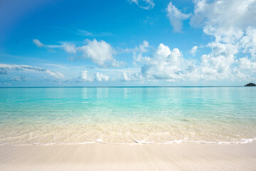 Beautiful summer sandy beach with white sand and calm wave of turquoise ocean on sunny day....