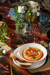 Colorful table setting with hummus and garnishes
