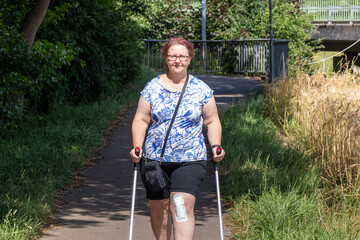 Walking exercises with crutches along a grain field