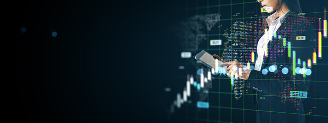 Businesswoman using tablet analyzing global stock market data with digital financial graphs and world map interface on dark background.