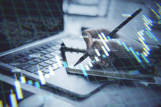 Businessperson analyzing financial data with digital stock market graphs overlaid on office desk with laptop and notebook in modern fintech concept. - Powered by Adobe