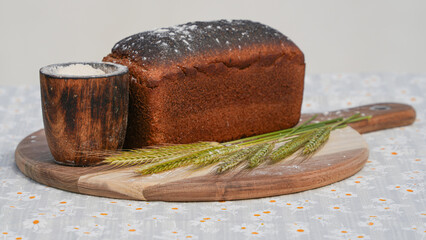 rye bread on a wooden tray with rye  ears