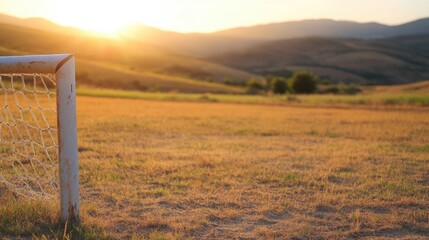 Empty soccer goal at sunset landscape