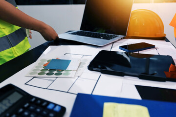 Closeup of team of industrial engineers meeting analyze machinery blueprints consult project on...