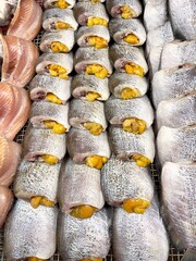 Sun dried snakeskin gourami fish with spawn in Thailand traditional local market, selective focus