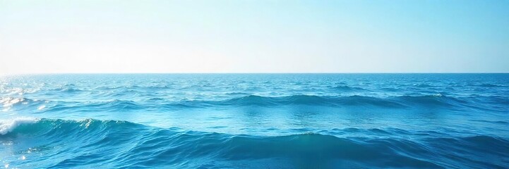 Obraz premium Serene Ocean Seascape Calm Waves Rolling Under a Clear Sky, Peaceful Tranquil Horizon, Perfect for Travel and Relaxation Themes