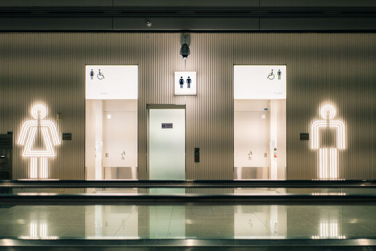 Seoul, South Korea - 16 may 2025 Toilets icon. Public restroom signs with a disabled access symbol. Interior of airport terminal