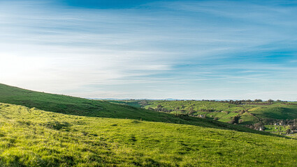 Tranquil Hill Slope Landscape Under Soft Blue Sky.  Tranquil Open Space. Nature Background