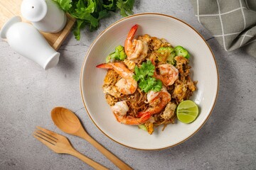 Stir-fried Thin Rice Noodles with dark Soy Sauce and shrimp in ceramic plate,