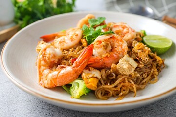 Stir-fried Thin Rice Noodles with dark Soy Sauce and shrimp in ceramic plate,