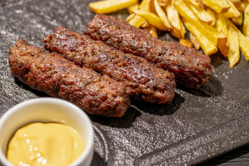 details of tasty romanian mici with fries