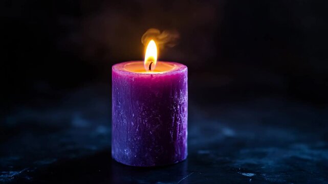 Purple candle burning on dark background with copy space