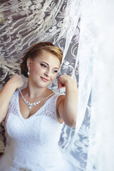 A woman in a white dress is posing for a picture