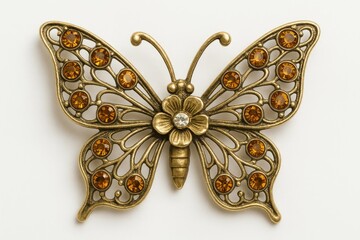 Fototapeta premium Elegant butterfly-shaped brooch crafted from metal, set against a white background
