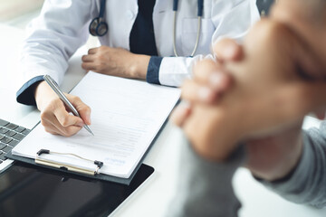 Doctor and patient at hospital office. Doctor working on diagnostic examination on men's health...