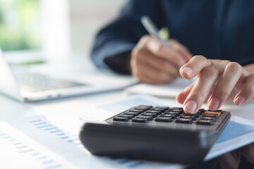 Business finance accounting banking concept. Businesswoman doing finances, using calculator to...