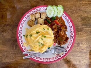 Thai Beef curry (Panaeng neua) serving with omlette,  deep fried chicken rolls and rice. Thai food. Selective focus, top view