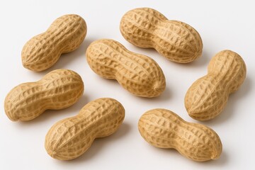 Detailed close-up of whole peanuts on a white surface