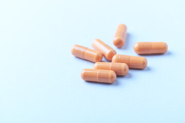 Calcium carbonate capsules. Bright paper background. Soft focus. Close up. Copy space.	