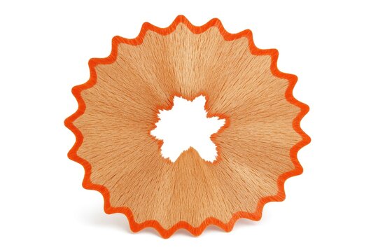 Close-up of a pencil shaving seen from the front on a plain white surface