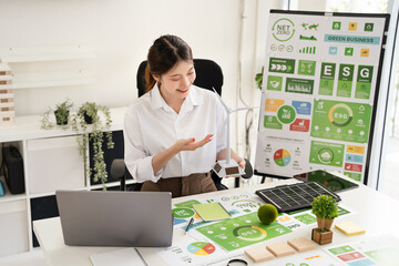A businesswoman in video call meeting presenting Net Zero and ESG targets by renewable energy.
