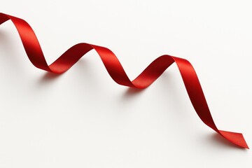 A crimson satin bow displayed against a plain white backdrop