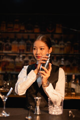  Professional female bartender preparing alcoholic drinks in a bar