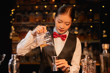  Professional female bartender preparing alcoholic drinks in a bar