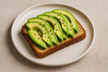 Fresh avocado slices and sesame seeds arranged on a plate for a sandwich