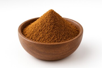 Spiced ground cinnamon in a dish against a plain white backdrop
