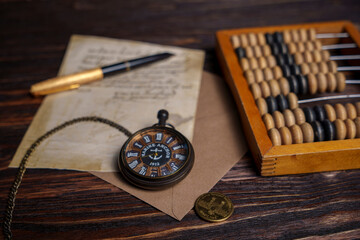Vintage still life with pocket watch, pine cones, handwritten letter, and newspaper