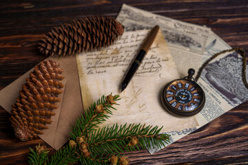 Vintage still life with pocket watch, pine cones, handwritten letter, and newspaper
