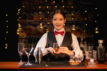  Professional female bartender preparing alcoholic drinks in a bar
