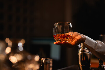 Professional female bartender preparing alcoholic drinks in a bar