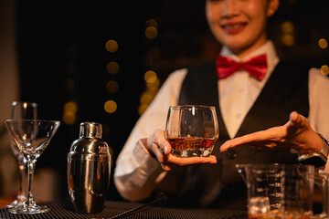  Professional female bartender preparing alcoholic drinks in a bar