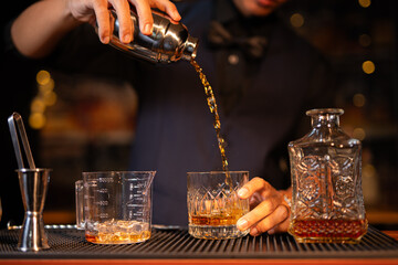  Professional male bartender preparing alcoholic drinks in a bar