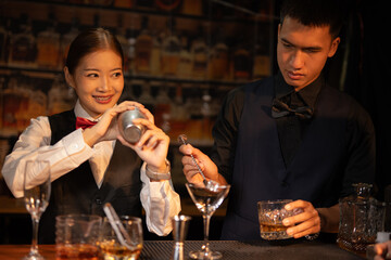  Professional male bartender preparing alcoholic drinks in a bar