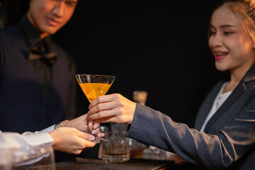  Professional female bartender preparing alcoholic drinks in a bar