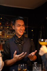 Professional male bartender preparing alcoholic drinks in a bar