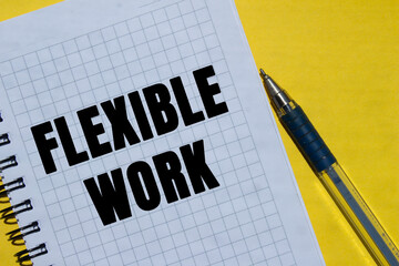 Flexible work message written on notebook page on yellow background. Conceptual flexible work...