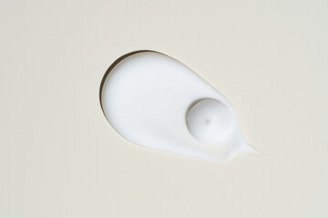 High-shine cream swipe on neutral beige, showcasing deep hydration and a plumping finish for...