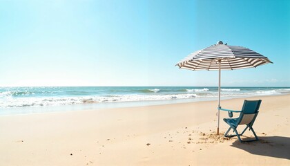 Beach chair with umbrella by the ocean under clear blue sky  