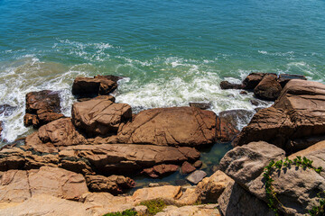 Captivating Coastal View with Vibrant Waves and Rocky Shoreline